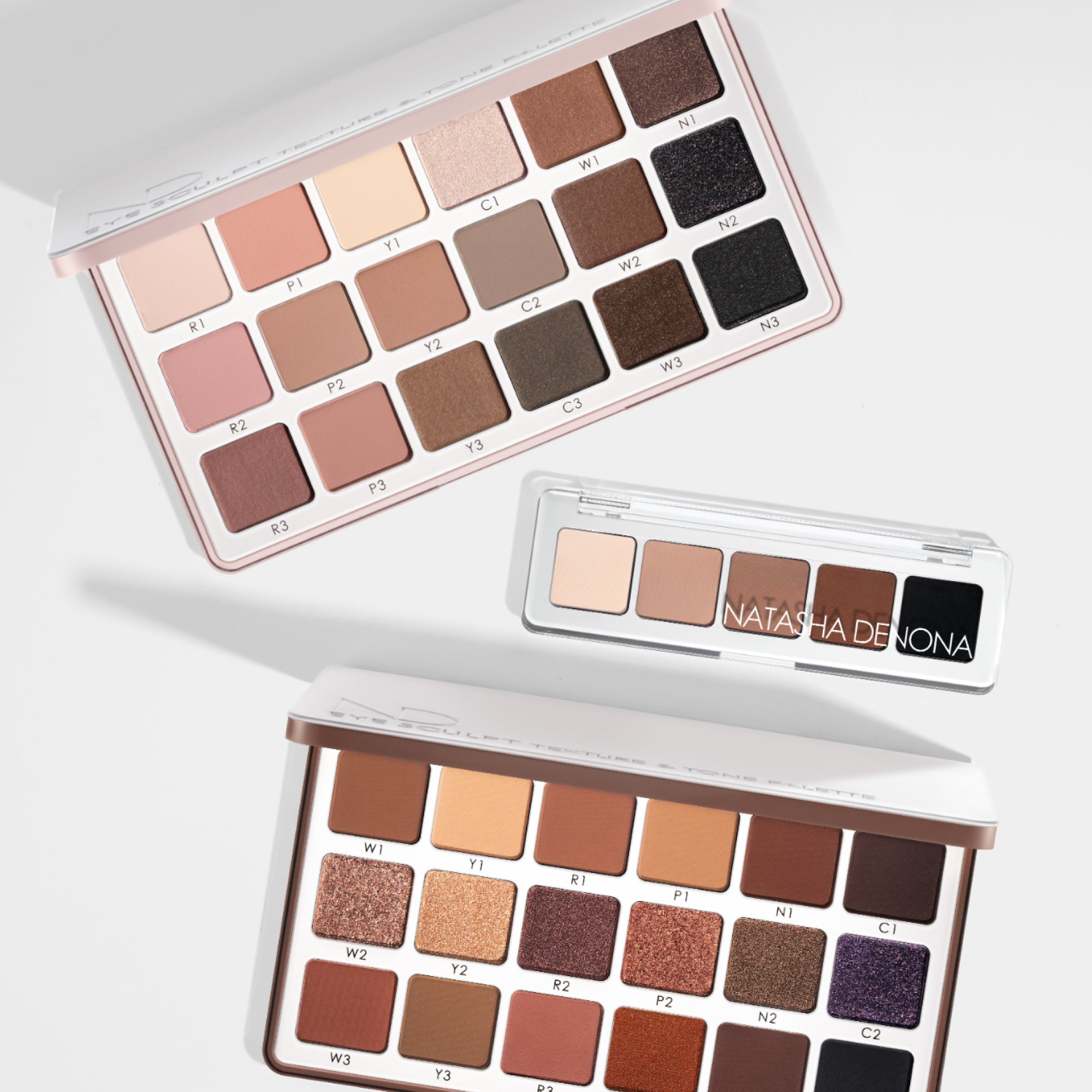 Eye Sculpt Texture and Tone Eyeshadow Palettes and Mini Eye Sculpt Original Eyeshadow Palette on a white background. Eye Sculpt Texture and Tone Eyeshadow Palettes and Mini Eye Sculpt Original Eyeshadow Palette on a white background.